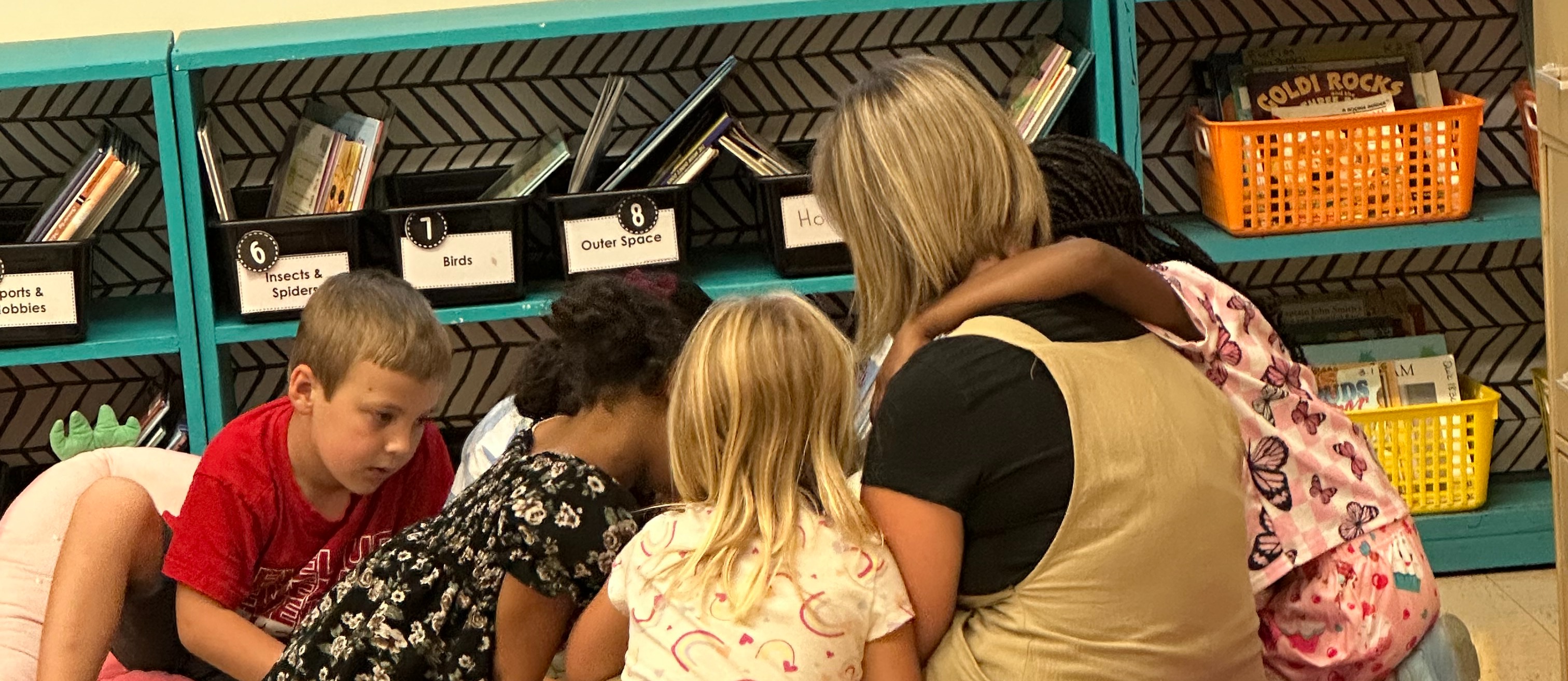 Teacher reading with students in a small group