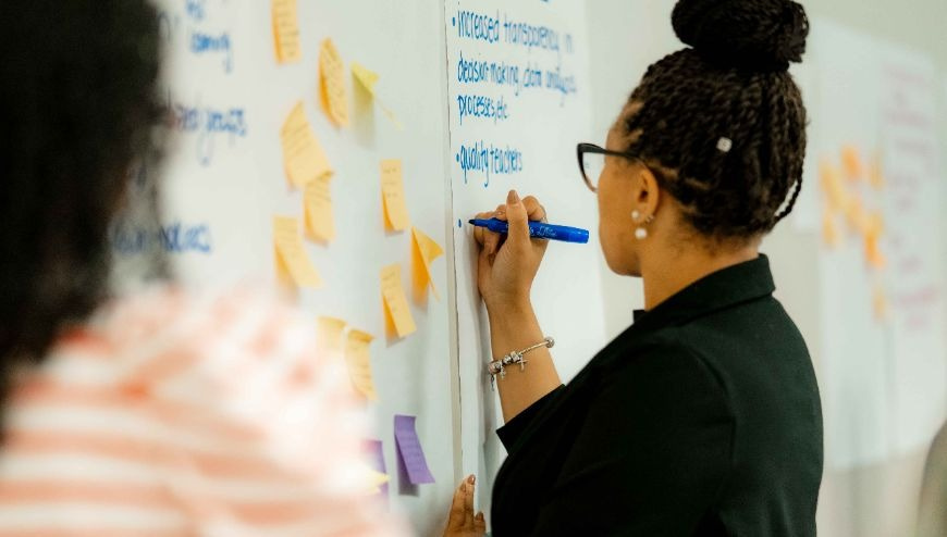 Image of person writing on chart paper