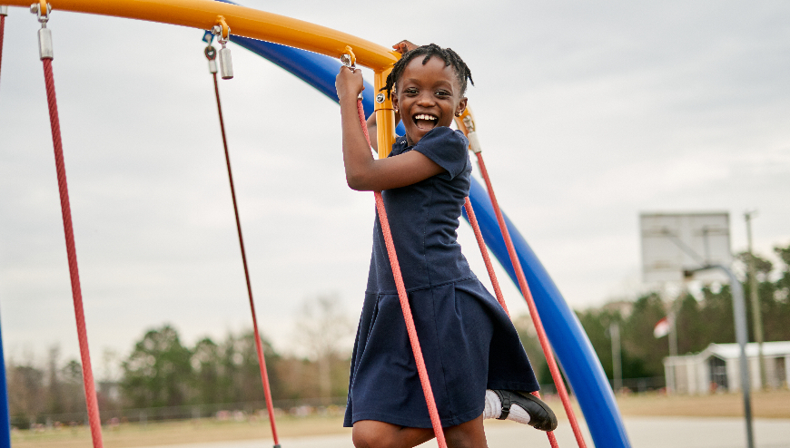 Image of child playing on playground equipment