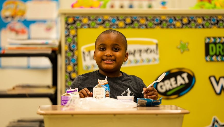 Male student k-5 eating breakfast