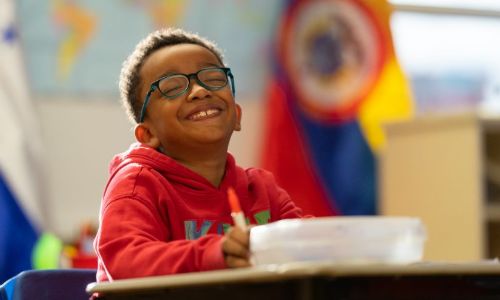 little boy with round glasses