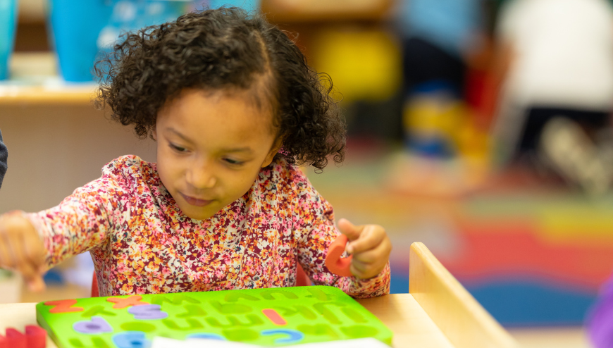 image of child putting puzzle together