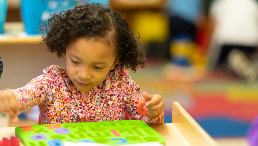 Image of child putting puzzle together