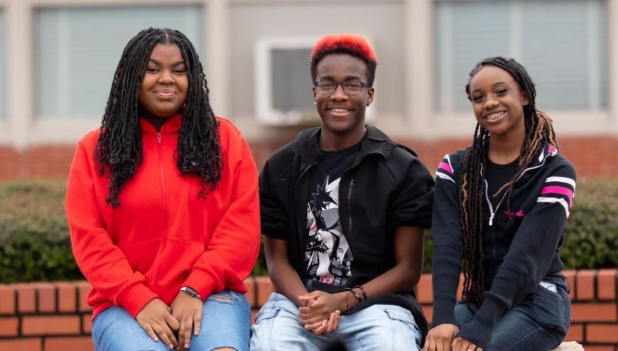 students sitting on bench