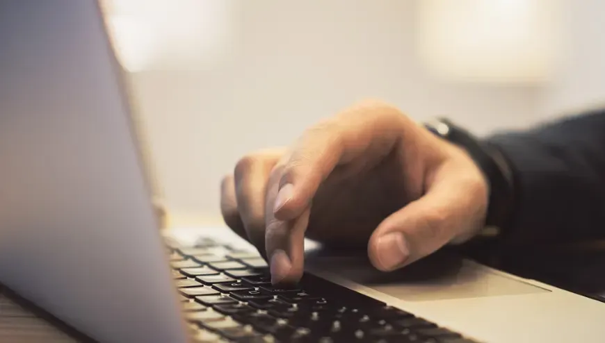 Hand on Laptop