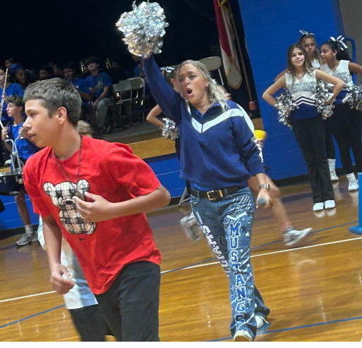 Principal Brooke Griffie cheering on students at pep rally
