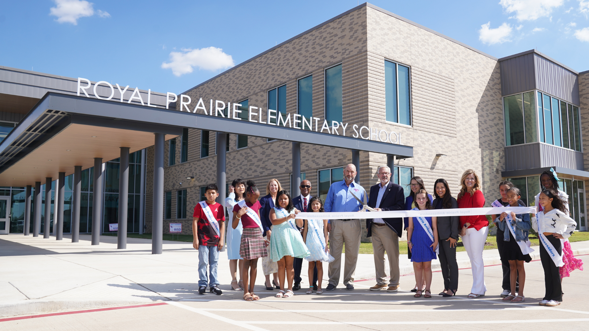 Royal ISD leaders, staff, students, and community members gather outside Royal Prairie Elementary School for the ribbon cutting ceremony.