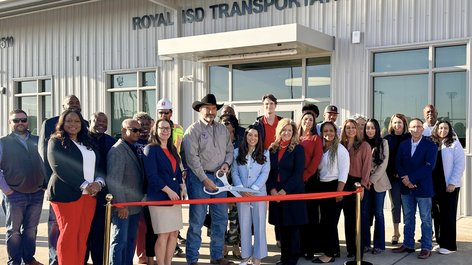 Royal ISD leaders, staff, students, and community members gather outside the Royal ISD Transportation Center for the ribbon cutting ceremony.