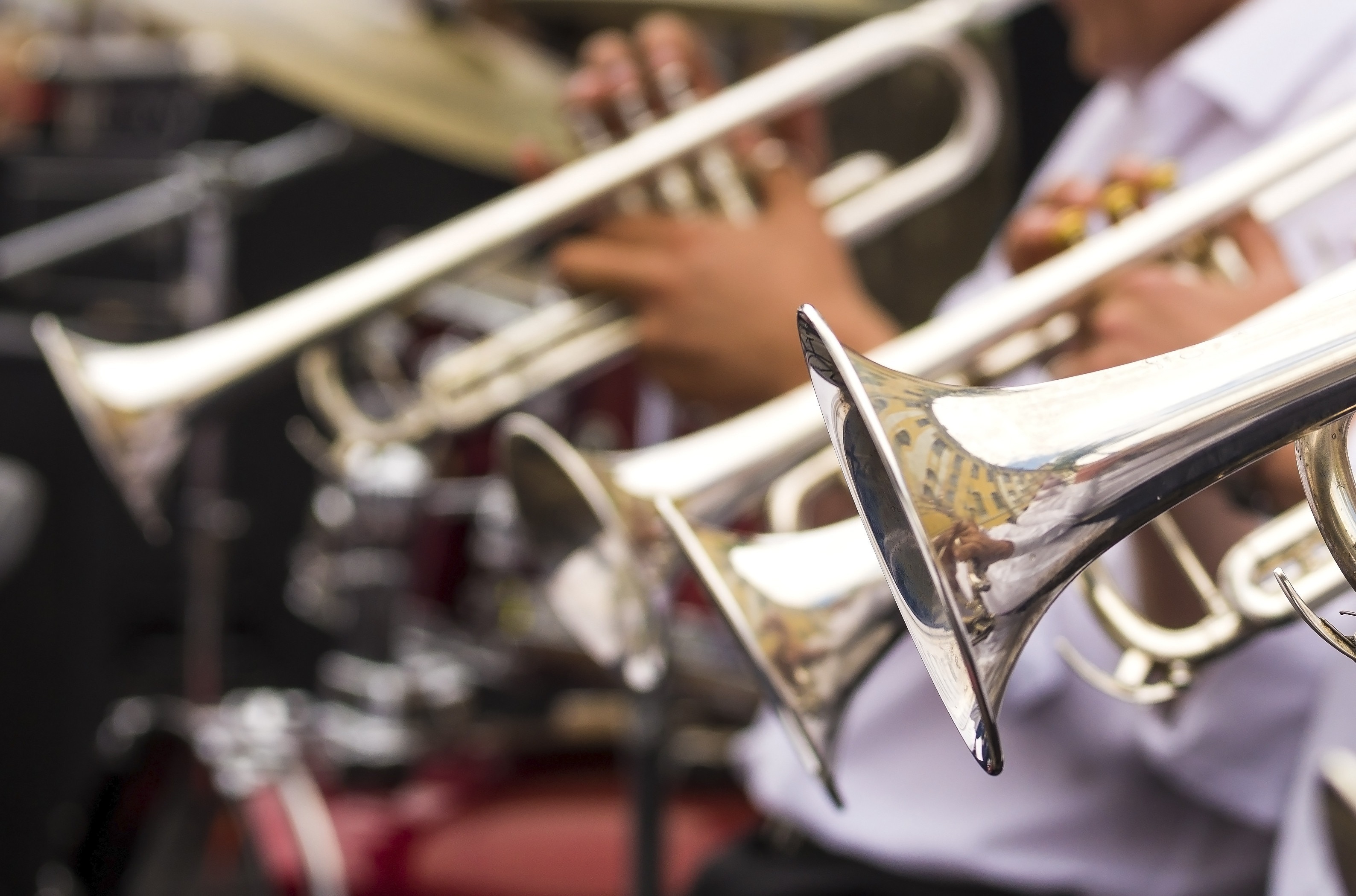 Image of trumpets and trombones being played