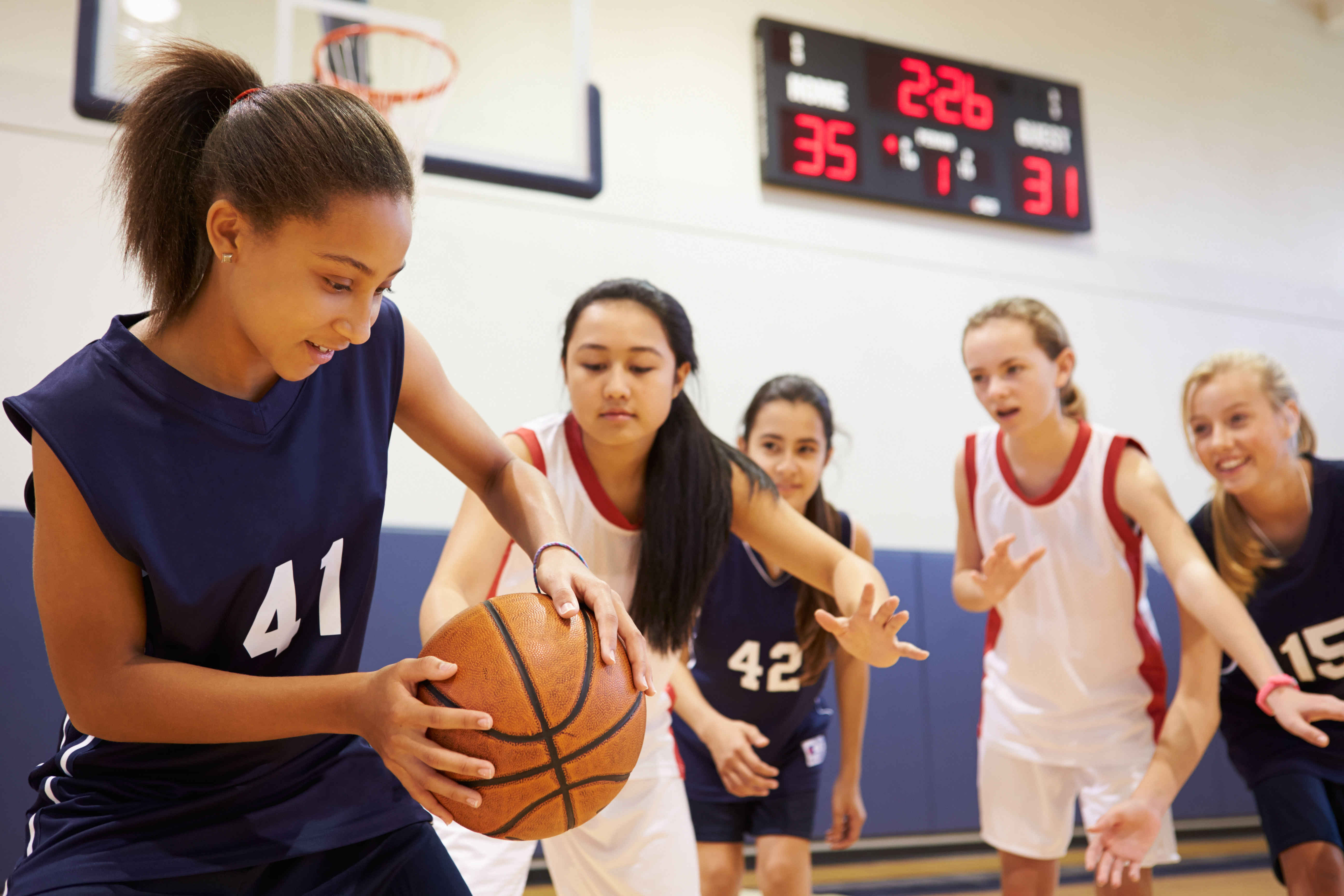 Female High School Basketball Team Playing Game