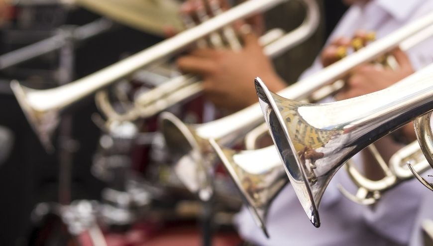 Image of trumpets and trombones being played