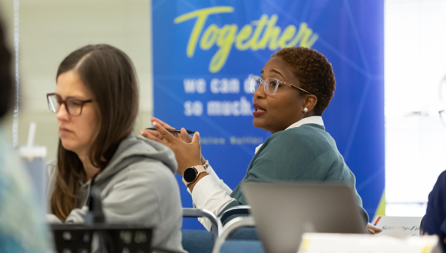 Two women at a meeting talking