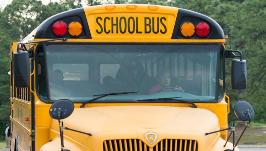  bus driver in front of bus