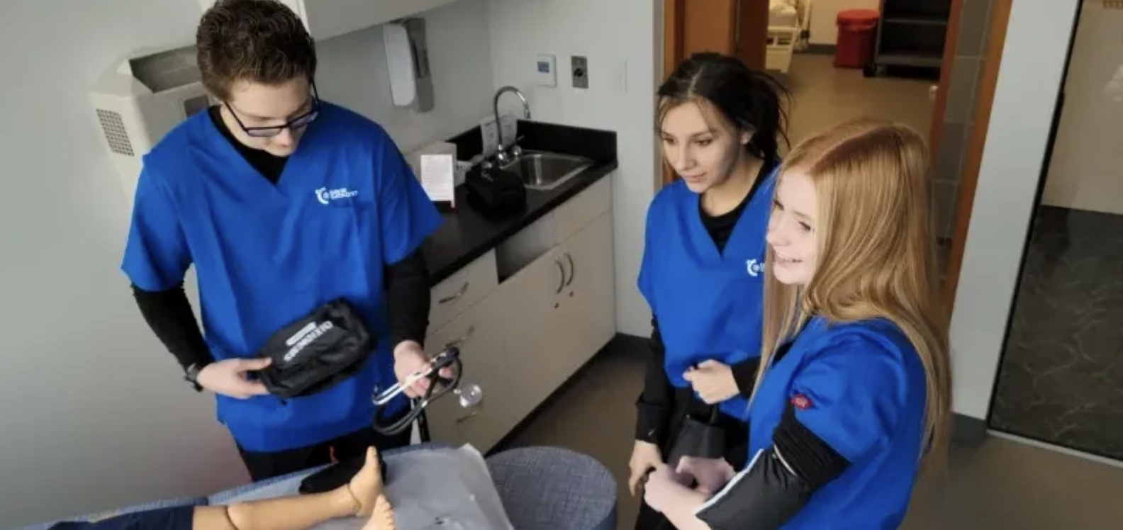 three students nurse practicing