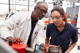 Photo of an industry person training a student for work-based learning