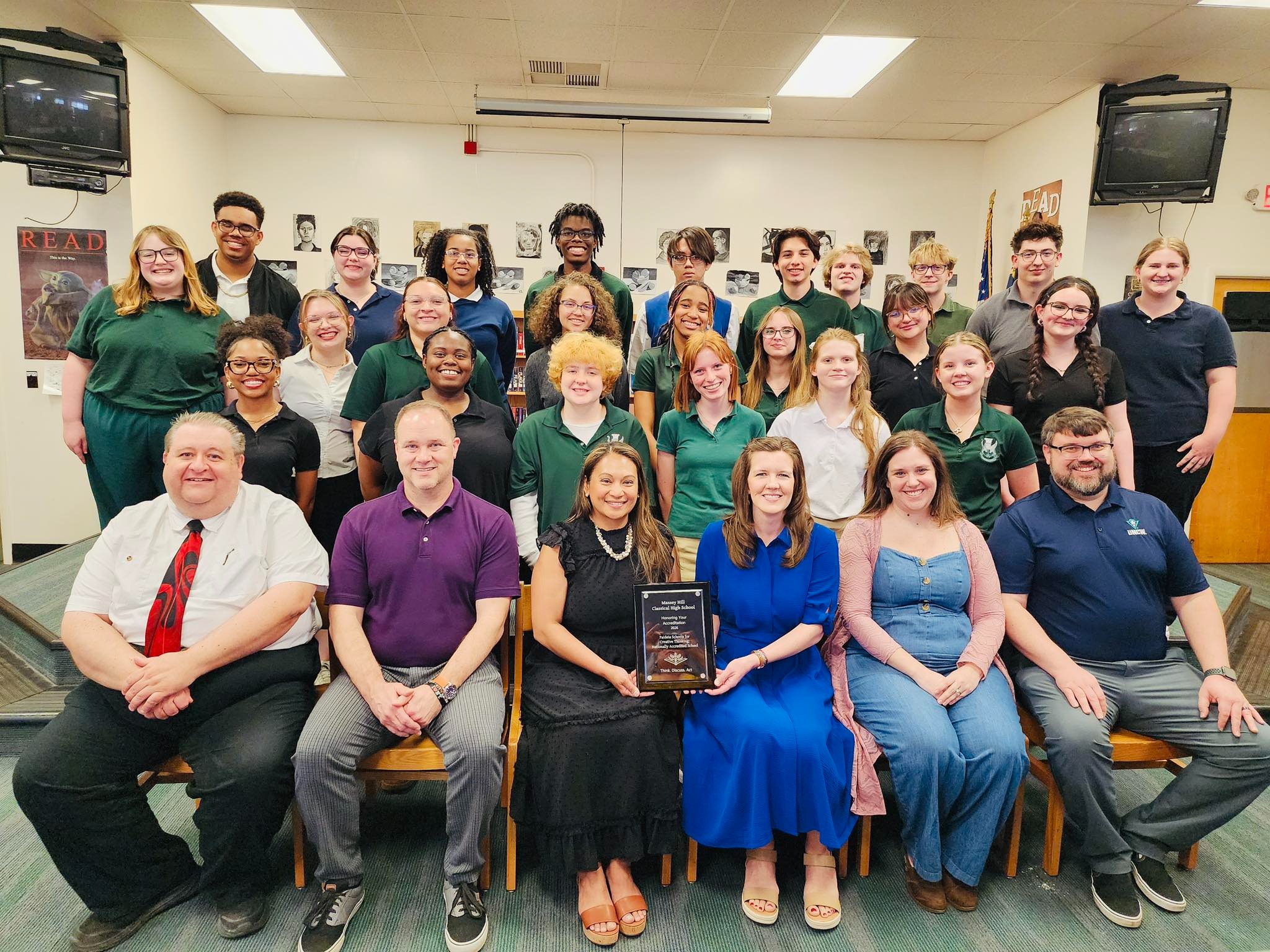 Paideia Team members with plaque