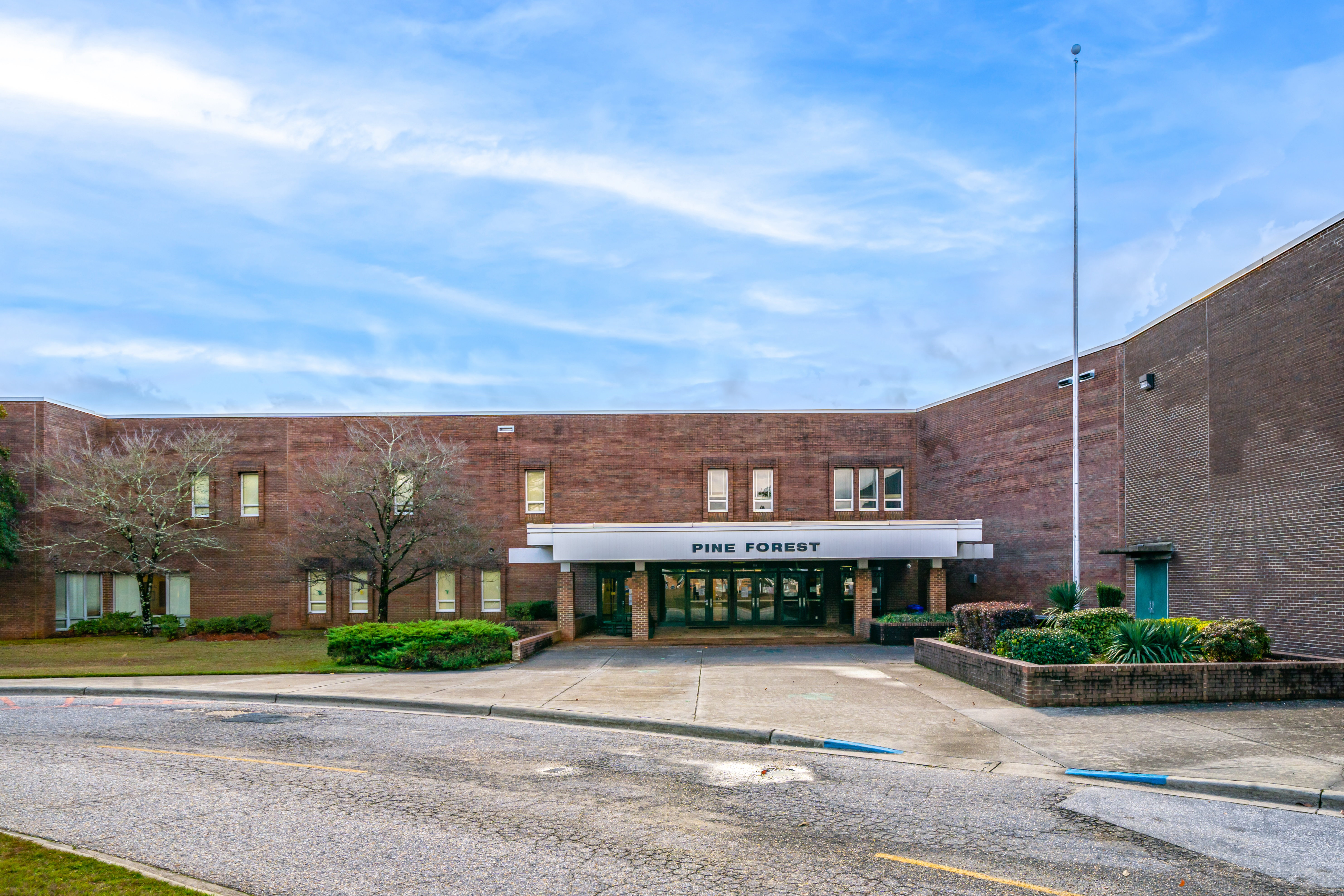 A photo of the front of pine forest  high school