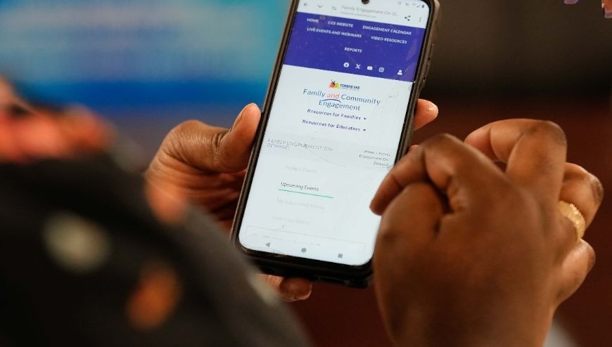 Cell phone with Family and Community Engagement on the screen