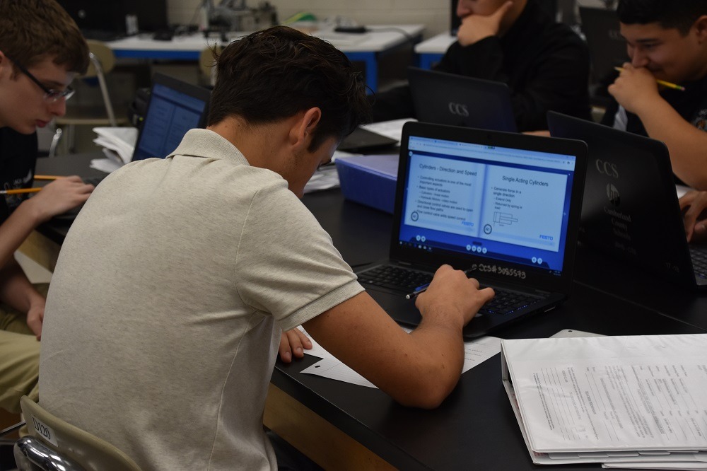 Teens working on laptop