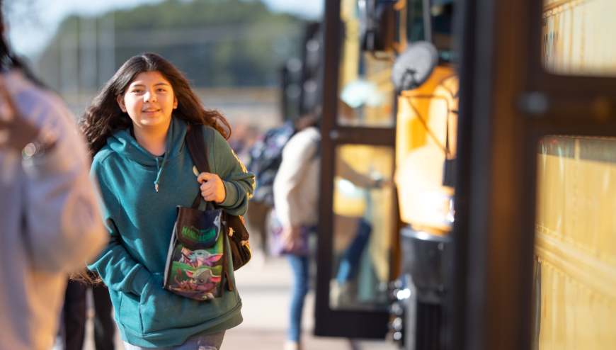 Buses with students walking