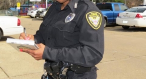 A police officer writing on a piece of paper