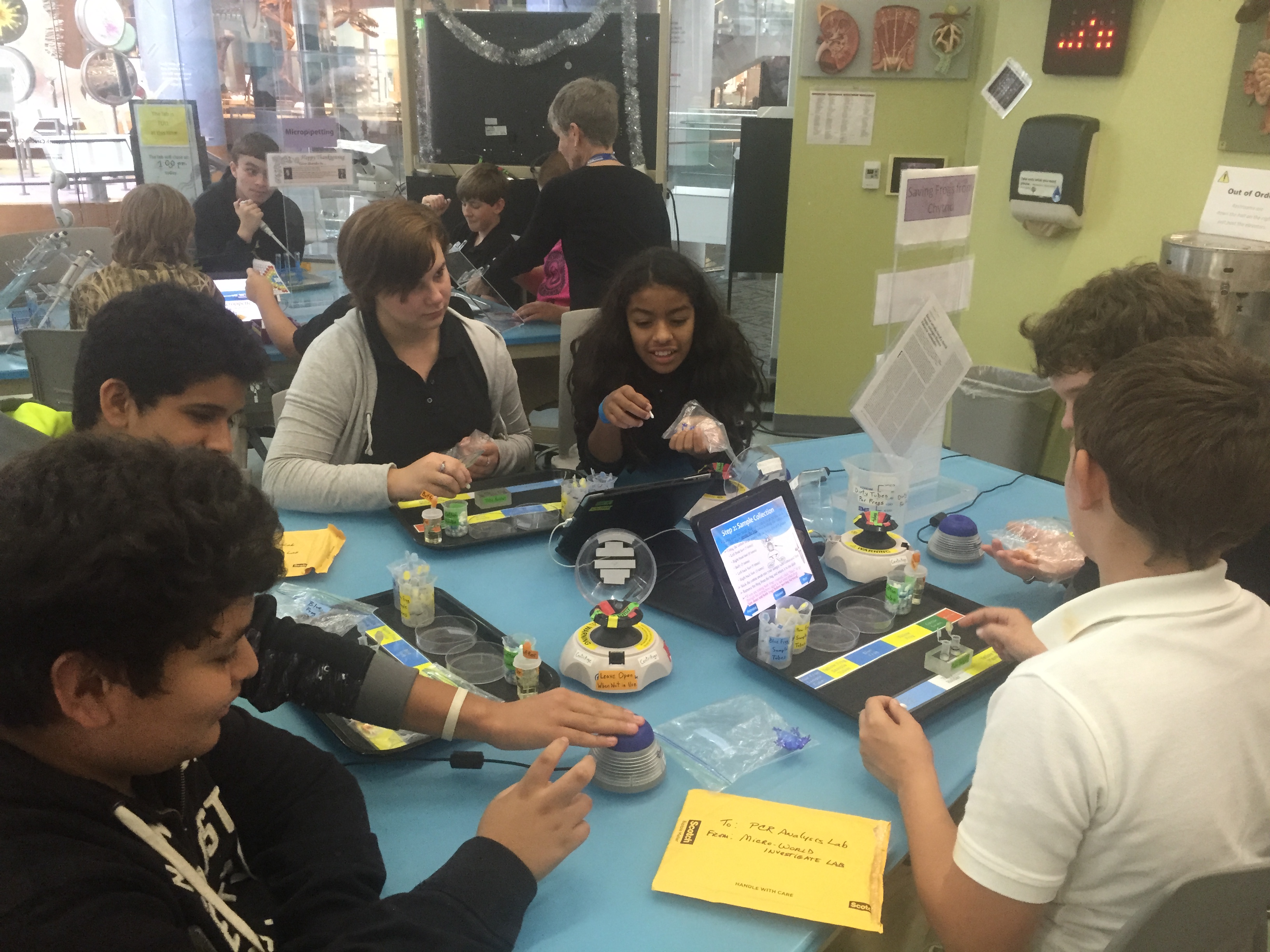 A group of students collaborating on a project at a table.