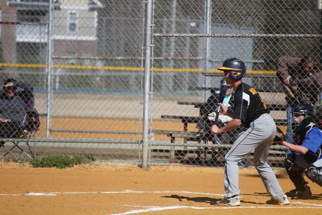 A baseball player swinging his bat at a ball during a game.