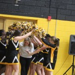 A group of cheerleaders standing in a gym