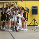 A group of cheerleaders standing in a gym