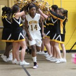 A group of cheerleaders standing in a gym