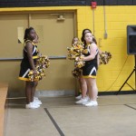 A group of cheerleaders standing in a gym