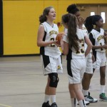 girls are playing basketball on a court