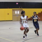 A girl is playing basketball on a court