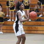 A girl is playing basketball on a court