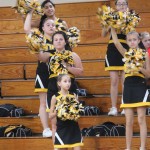 A group of cheerleaders standing on a bleachers