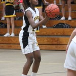 A girl is playing basketball on a court