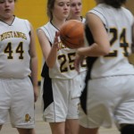 A girl is playing basketball on a court