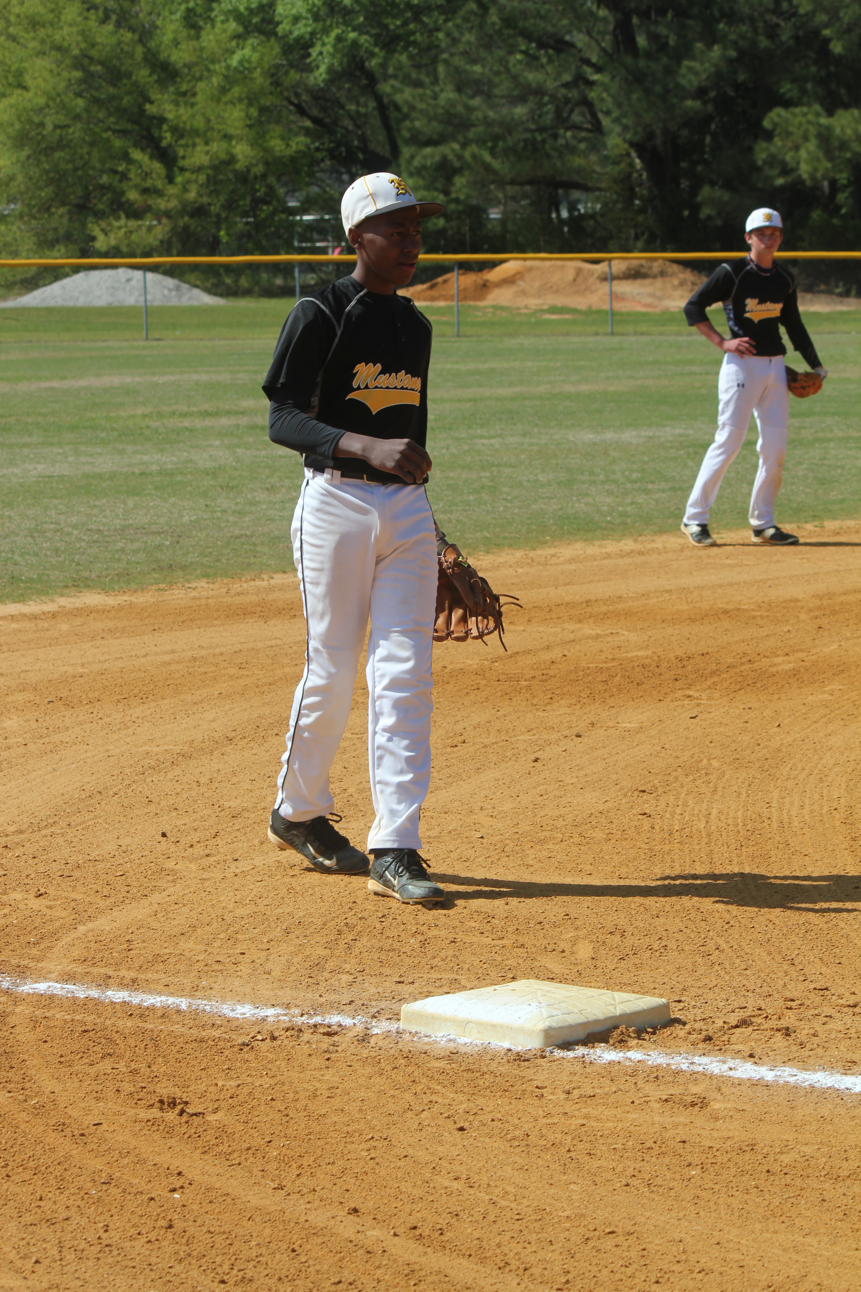 Baseball player standing in the outfield during a game.