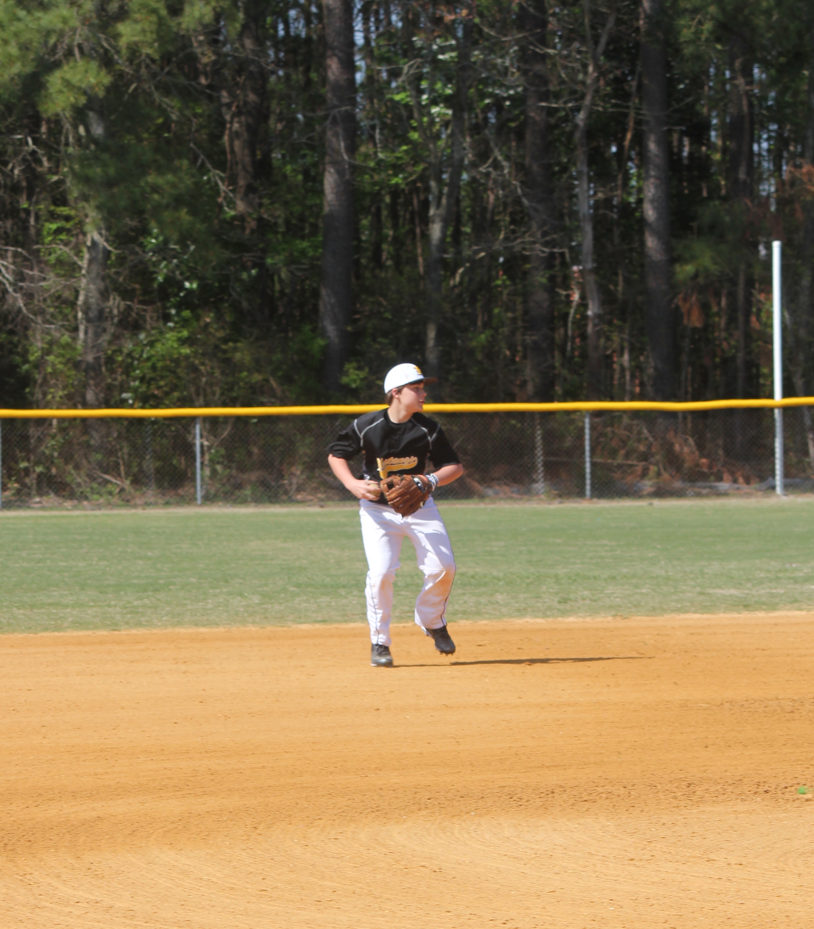 A baseball player ready to throw a ball in the outfield during a game.