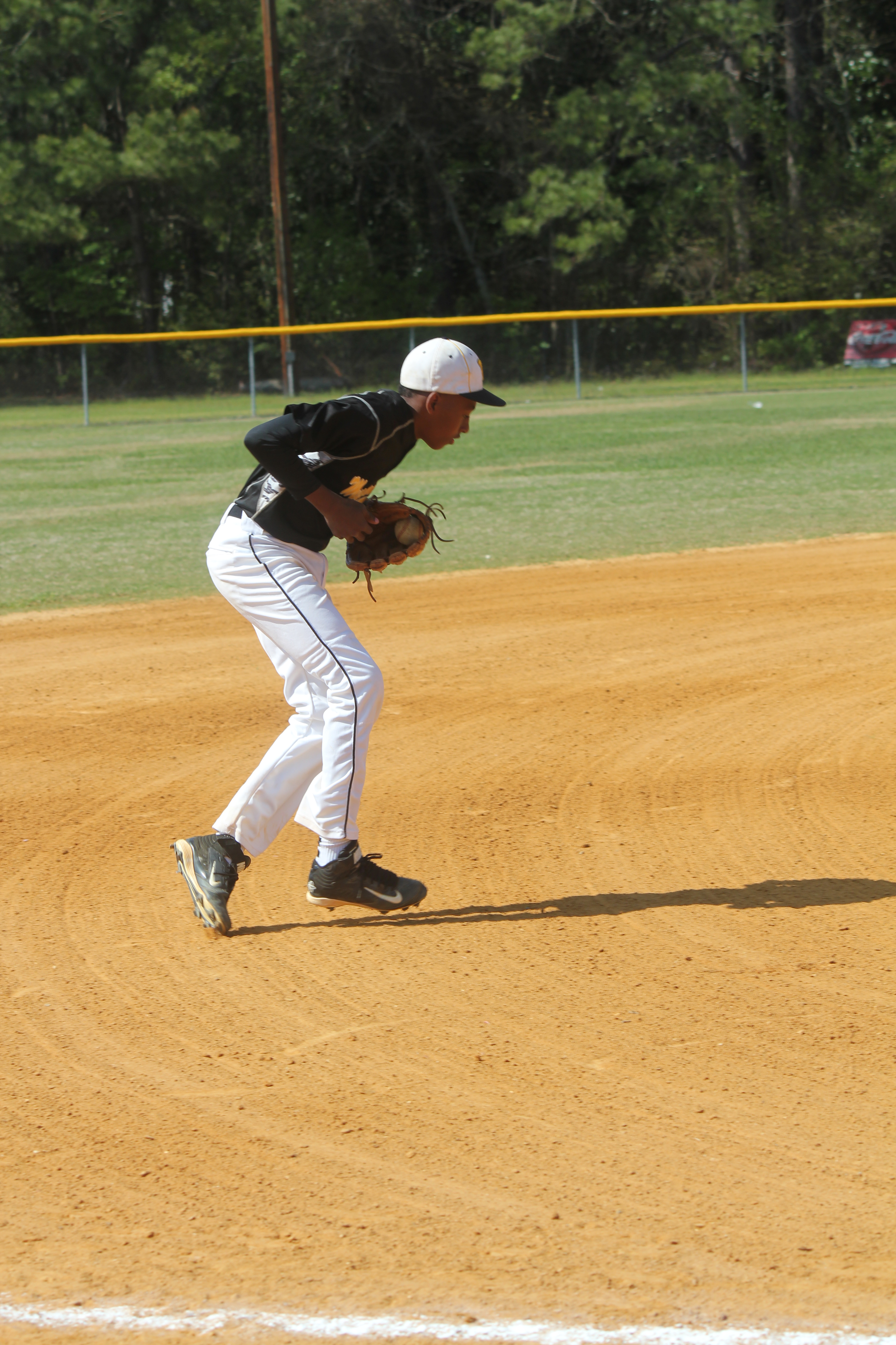 A baseball player ready to throw a ball in the outfield during a game.