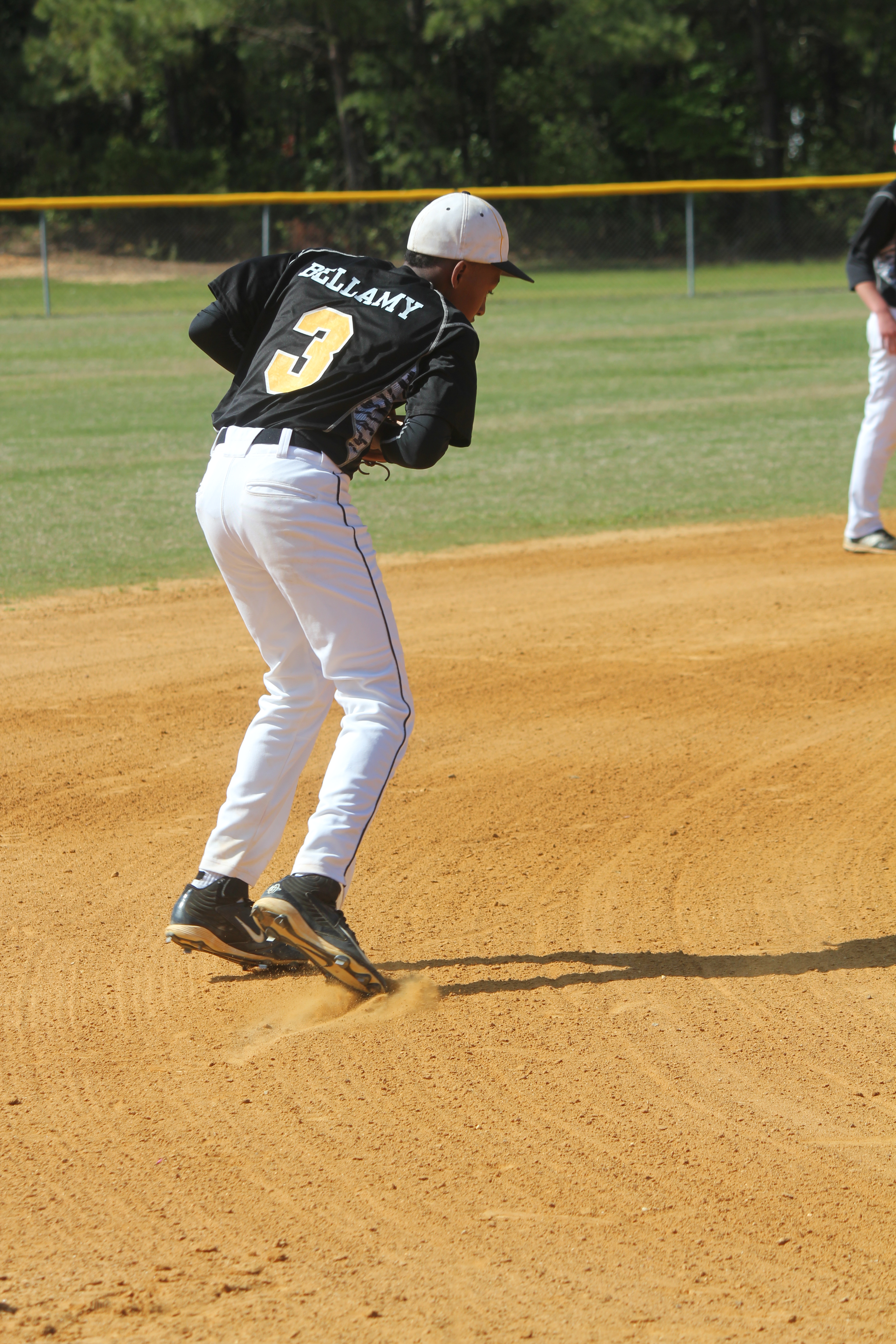 A baseball player ready to throw a ball in the outfield during a game.