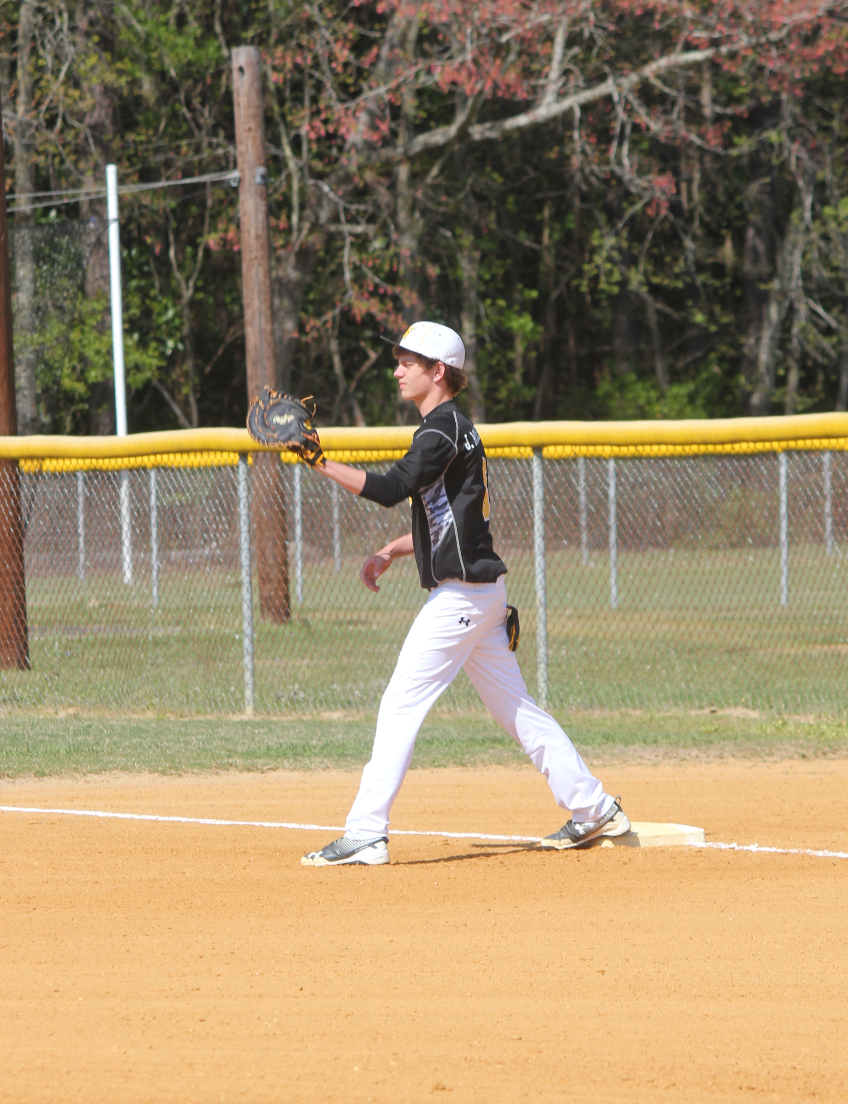 Baseball player standing in the outfield during a game.