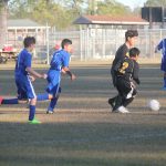 Image of soccer game with airborne ball.