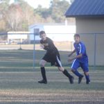 Image of soccer game with airborne ball.