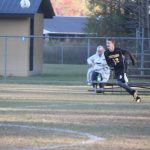 Image of soccer game with airborne ball.