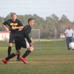 Image of soccer game with airborne ball.