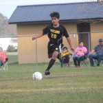 Image of soccer game with airborne ball.