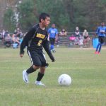 Image of soccer game with airborne ball.