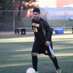 A young boy playing soccer on a field.