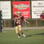 A football player running with the ball on the field